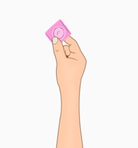Person holding a condom, one method of barrier contraception